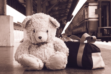 vintage tone, teddy bear sitting alone at Railway Platform